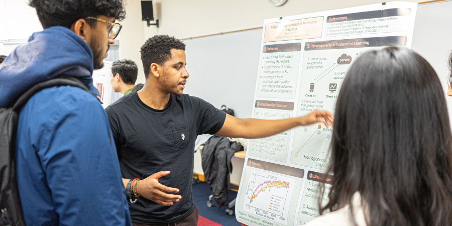 A student presenting his project during a poster session