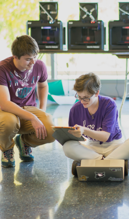 Two students working together in a hackathon