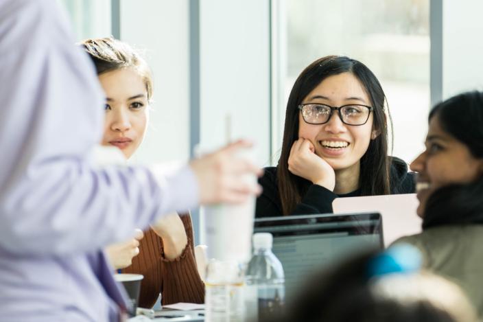 A group of female students chatting while working a project