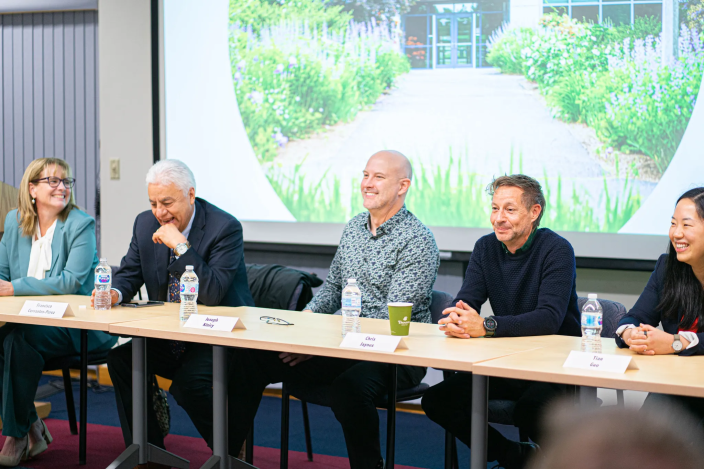 Panel of alumni sitting at table