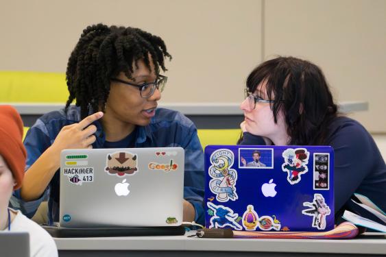 Two female students working together at a hackathon