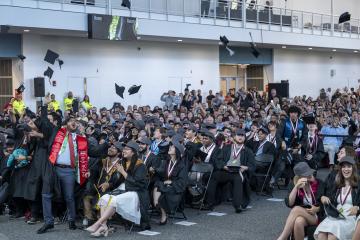 Members of the CICS Class of 2025 complete the iconic cap toss as their Senior Celebration