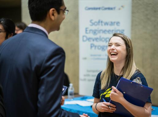 A recruiter interviewing a student in a career fair
