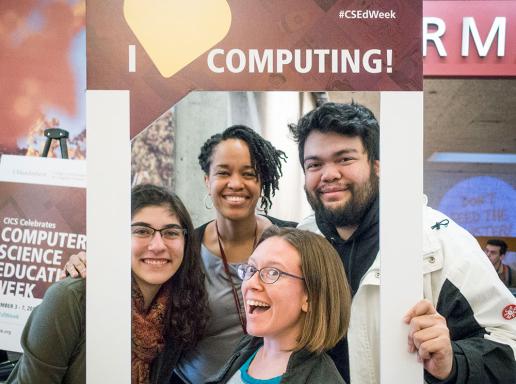 Students posing with I love computing poster
