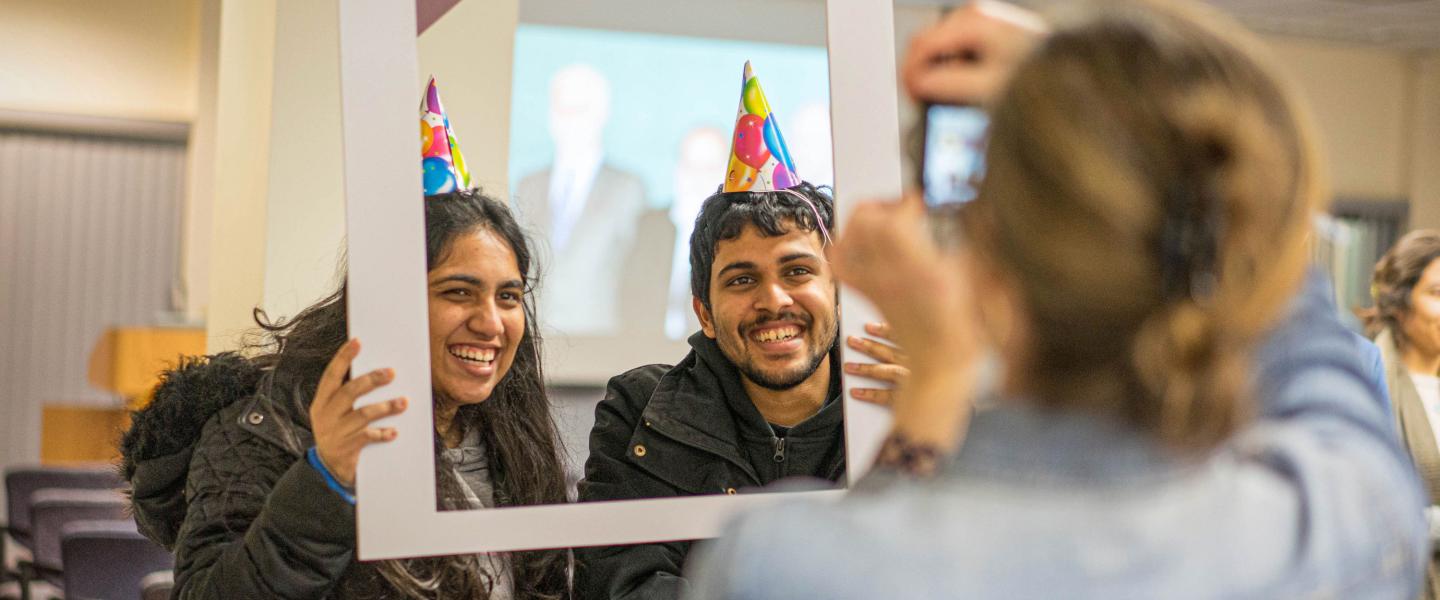 Two students holding a "I [heart] computing" photoframe
