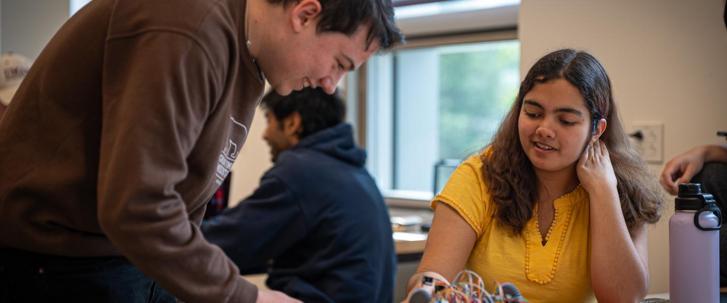 two students work on a project together