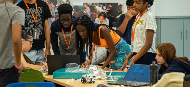 Massenberg students gathered around laptop
