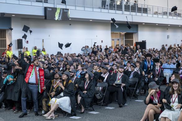 Members of the CICS Class of 2025 complete the iconic cap toss as their Senior Celebration