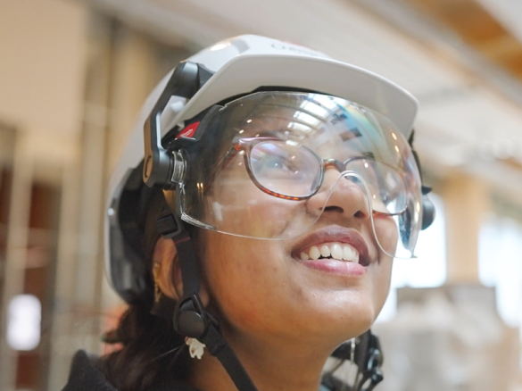 image of female student in protective gear exploring the new Manning CICS Computer Science Laboratories building