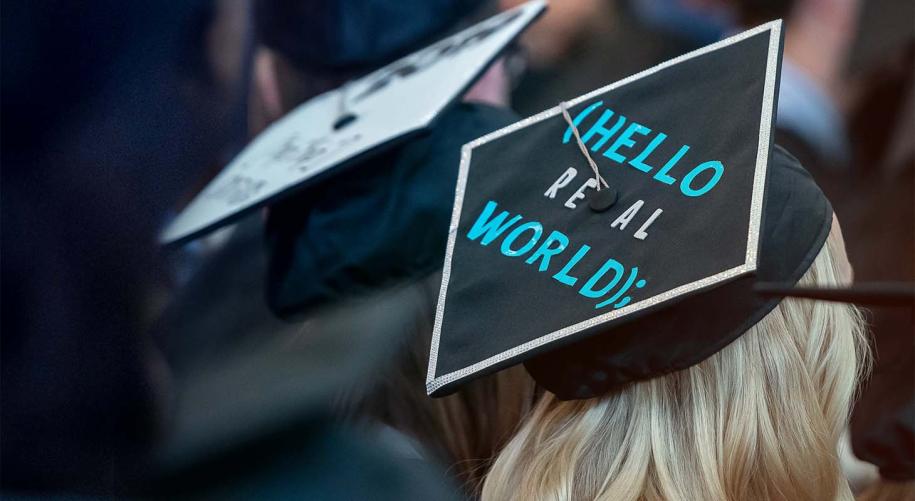 Photo of a female student's graduation hat that says "Hello World"