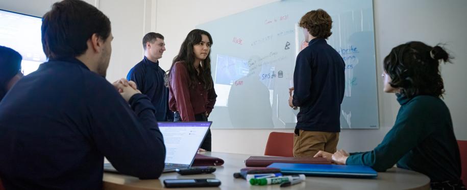 Student gathered around whiteboard