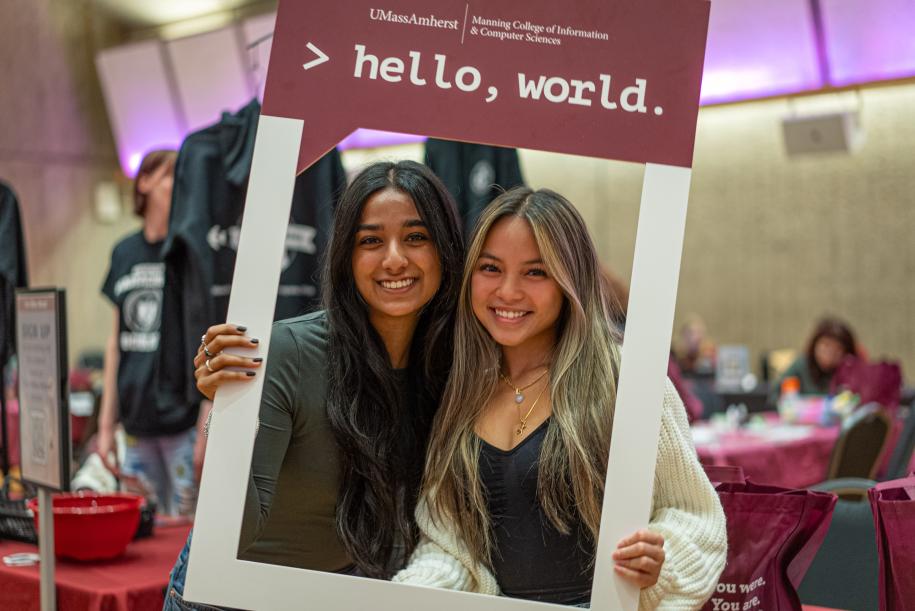 students holding 'hello, world' photo frame