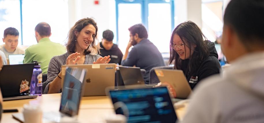 students at tables with laptops