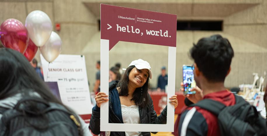 students holding phot frame: Hello World