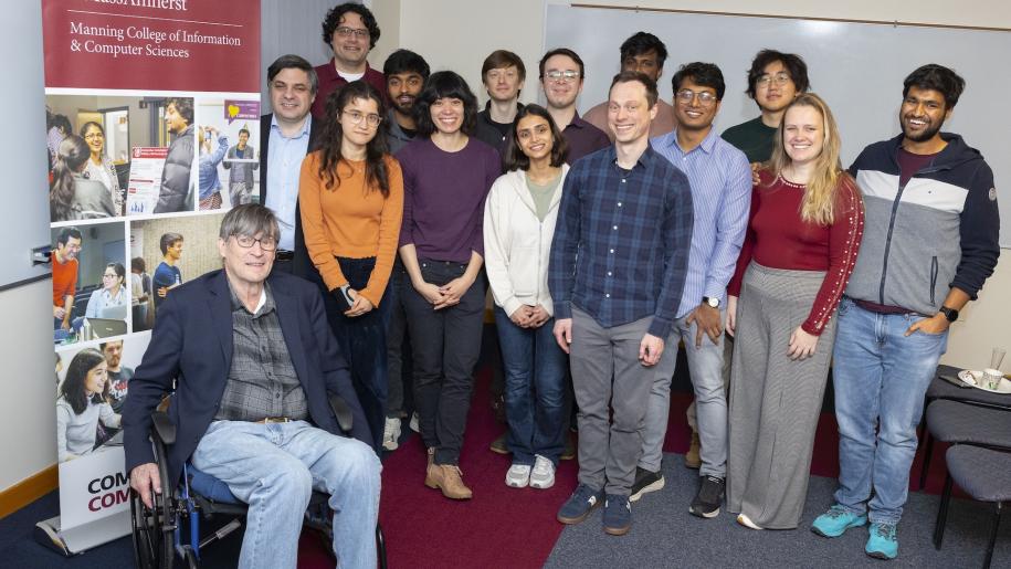 Andrew Barto poses for a photo with CICS students and faculty at an event celebrating the announcement of the Turing Award on March 5, 2025.