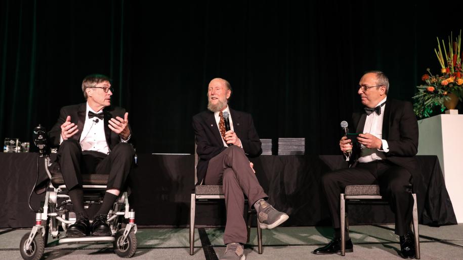 Andrew Barto (left) and Richard Sutton (center) discuss the development of reinforcement learning.